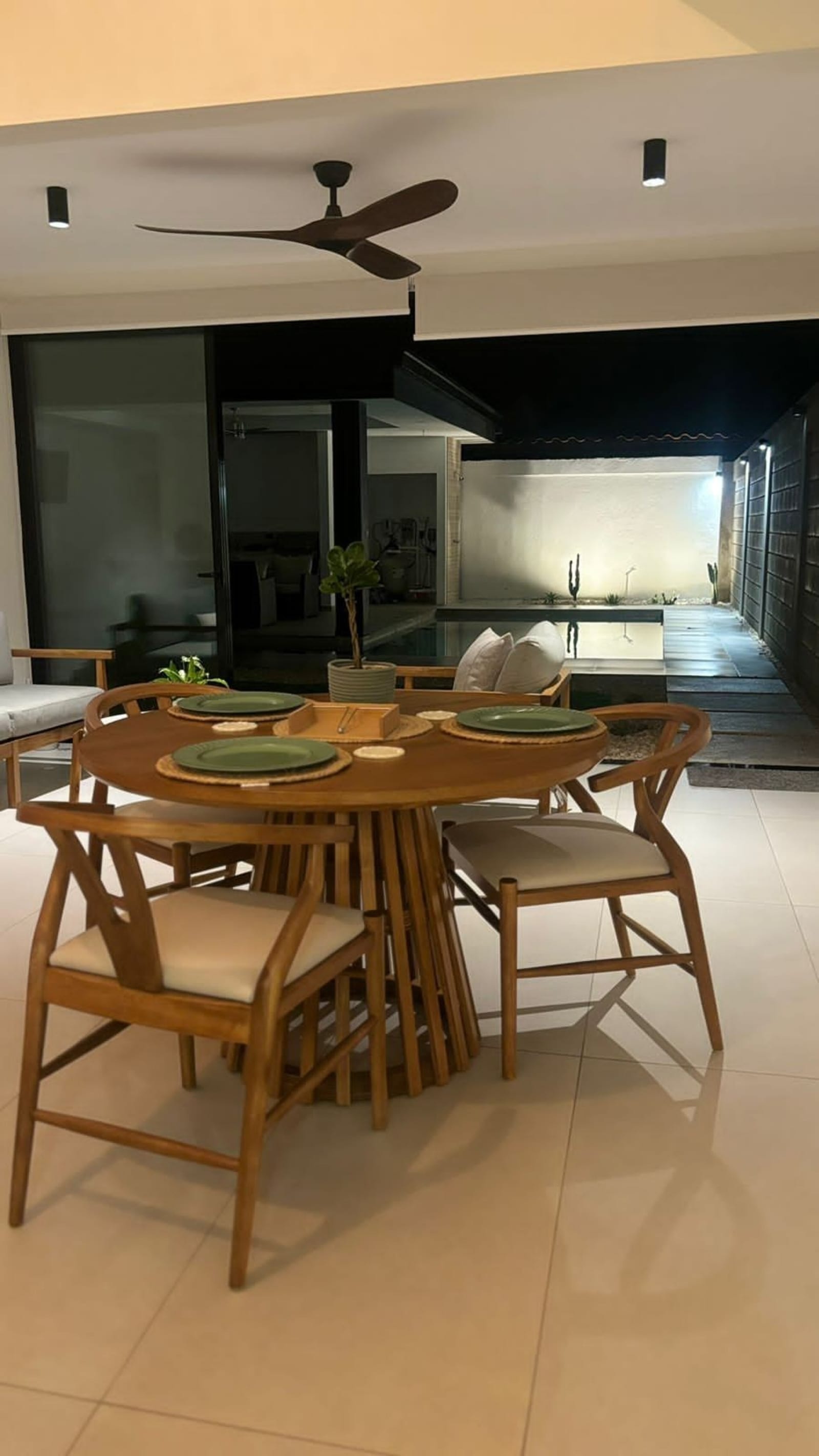 Dining table set with green plates at night
