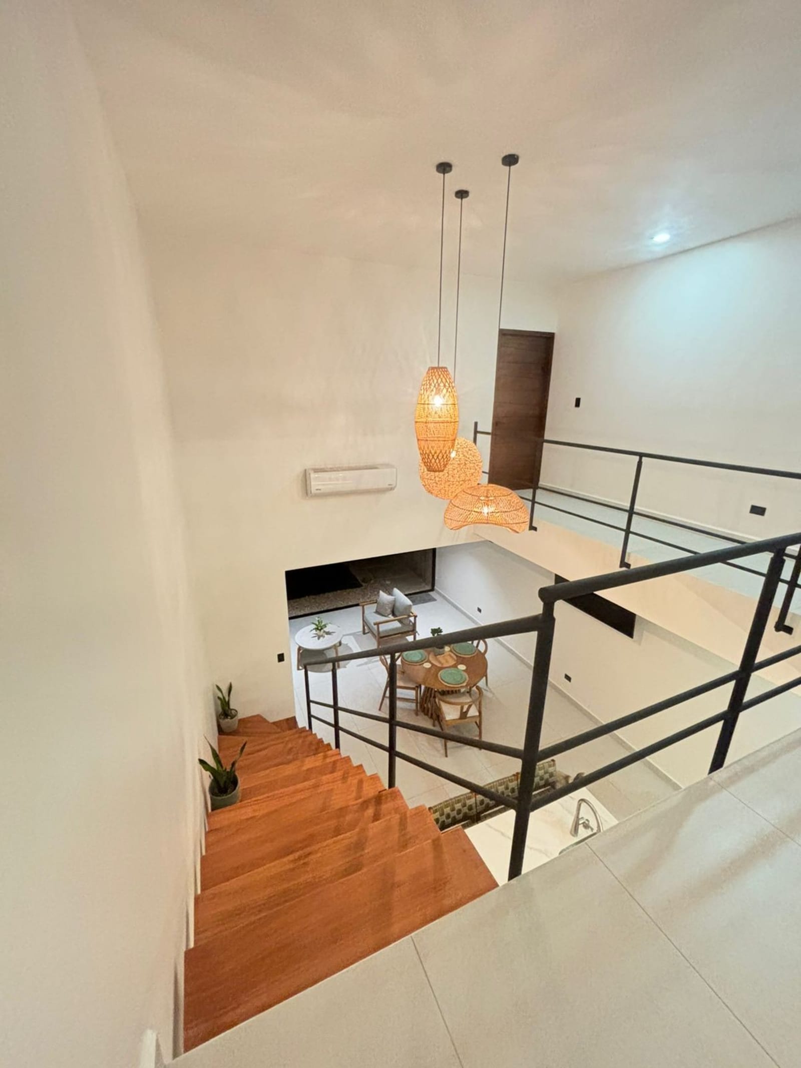 Rattan lamp over the stairwell and kitchen below