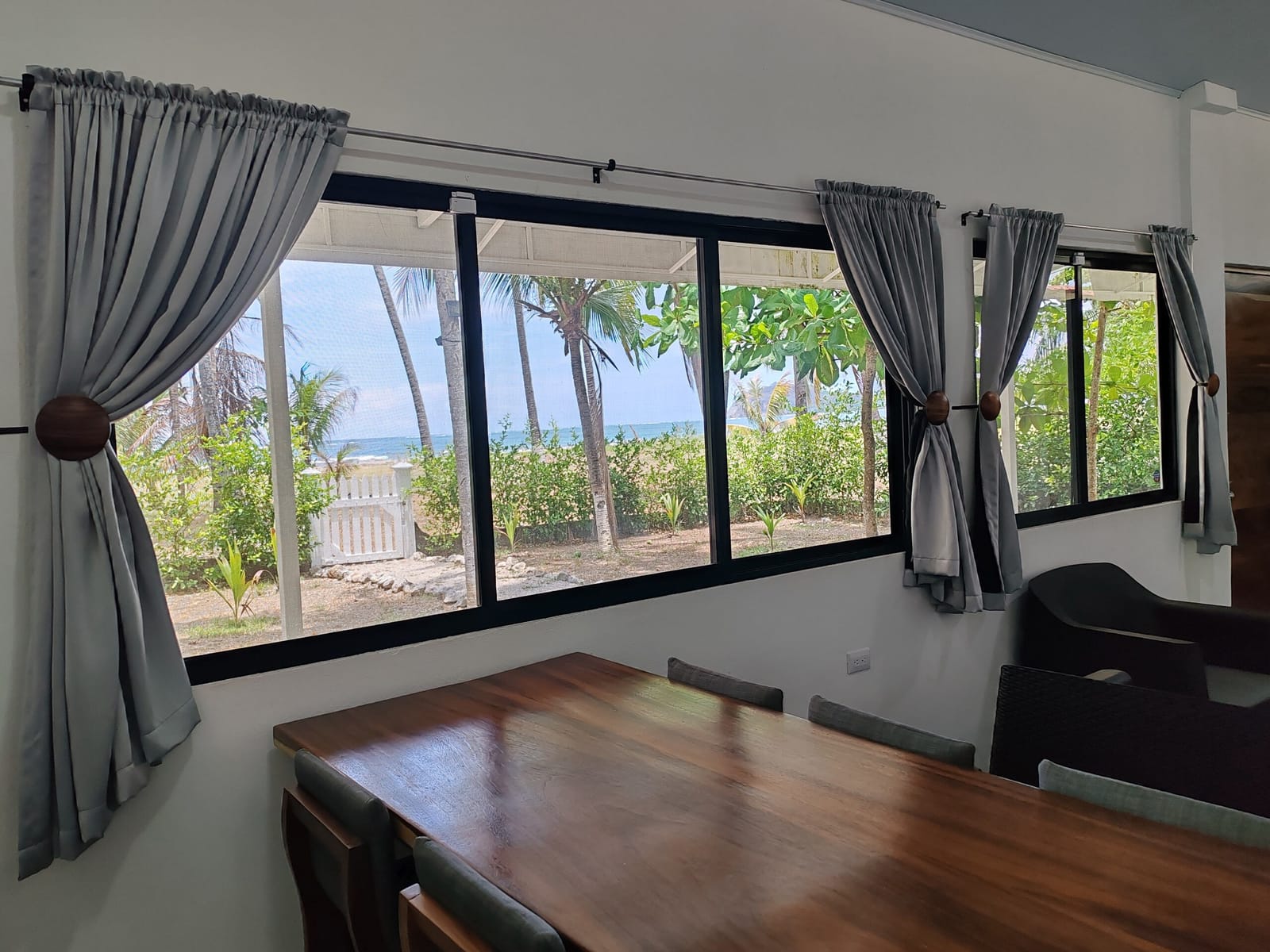 Long wooden dining table by the window with sea view
