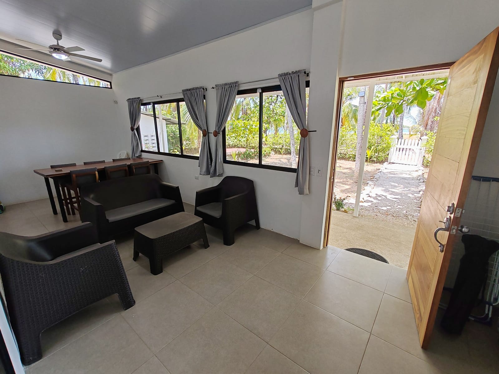 Rattan seating by the open front door to the garden