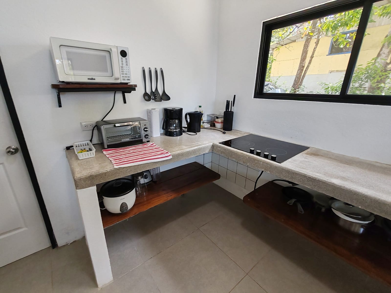 Kitchen counter with toaster oven, rice cooker and cooktop